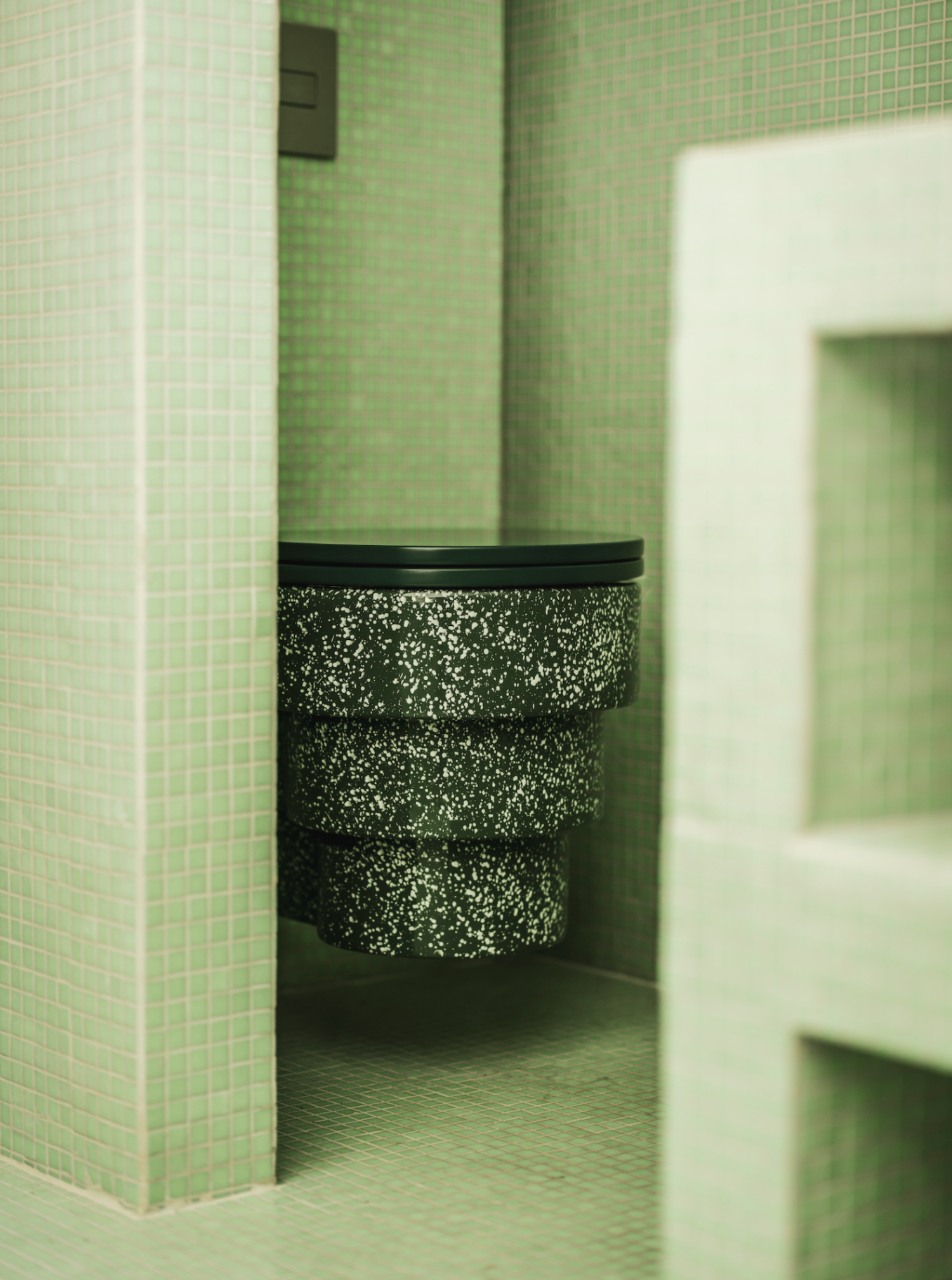 Green mosaic tiled bathroom detail