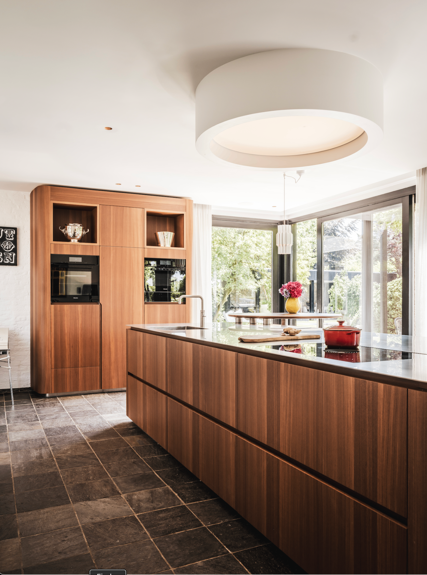 Walnut kitchen island with circular ceiling light